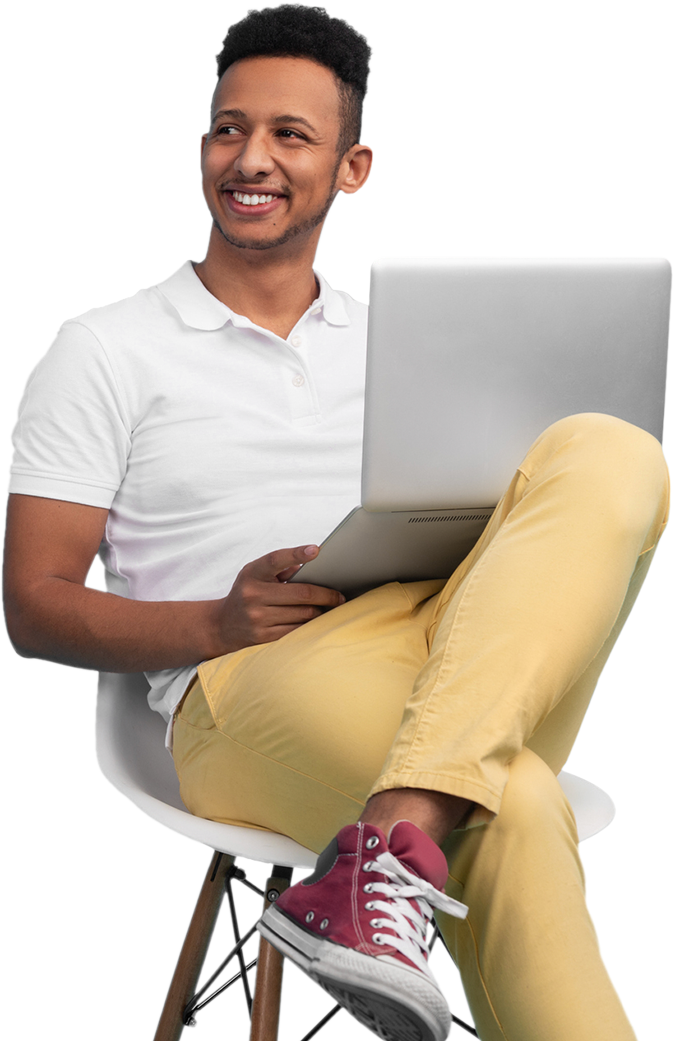 man smiling while using a laptop