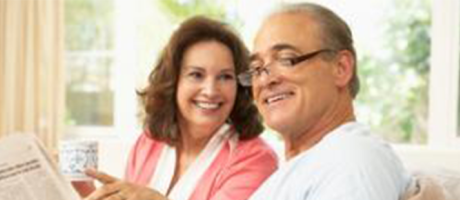 mature couple reading a newspaper