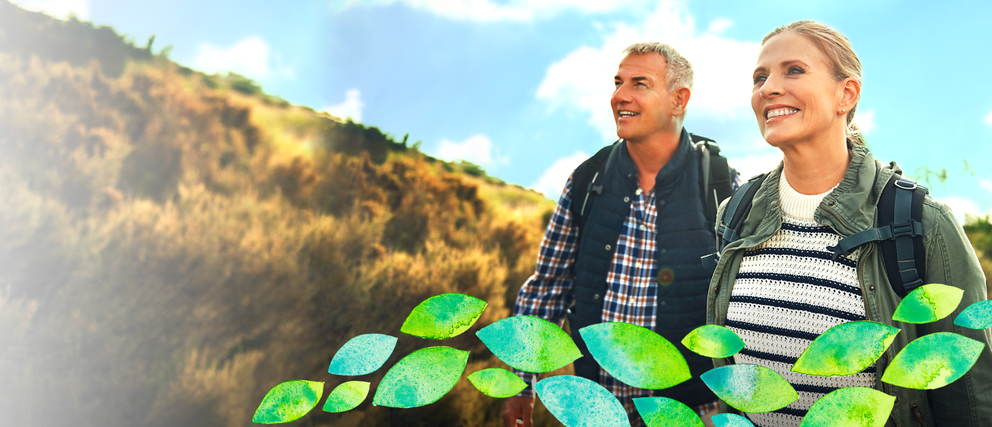 mature man and woman smiling on a hike