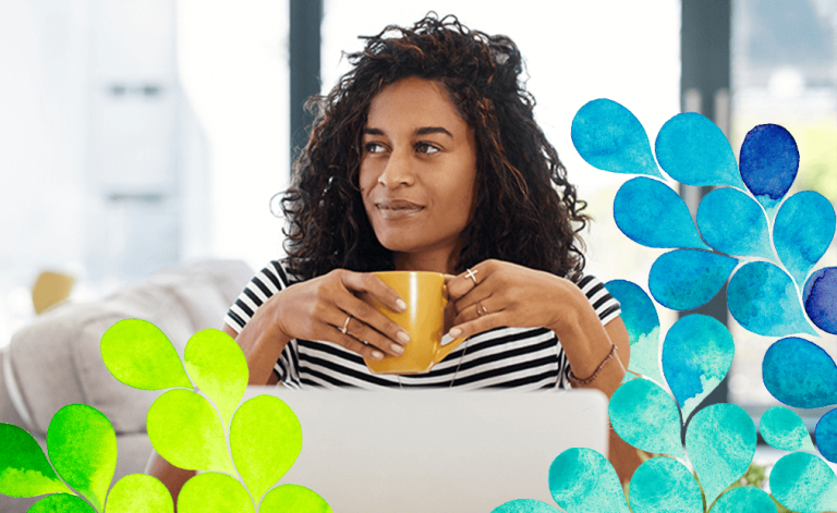 woman smiling and holding a mug in a cafe