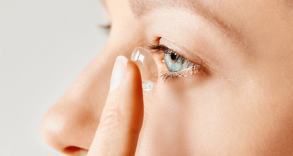 woman holding contact lens